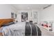 A cozy bedroom with a spacious closet, a comfortable bed, and a convenient changing table at 4663 S Lowell Blvd, Denver, CO 80236