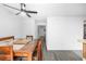 Bright dining room featuring wood floors and a stylish ceiling fan fixture at 4663 S Lowell Blvd, Denver, CO 80236