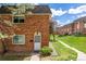 Charming brick townhouse featuring a well-maintained lawn and inviting front entrance at 4663 S Lowell Blvd, Denver, CO 80236