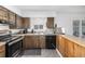 Cozy kitchen featuring wood floors, plentiful counter space and modern appliances at 4663 S Lowell Blvd, Denver, CO 80236