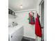 Practical laundry room with a washer, a dryer, and storage shelves for household essentials at 4663 S Lowell Blvd, Denver, CO 80236