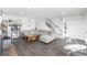 Spacious living room featuring hardwood floors, a staircase, and an abundance of natural light at 4663 S Lowell Blvd, Denver, CO 80236