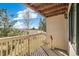 This beautiful outdoor balcony features wooden floors with a lovely view of the outdoor nature and blue skies at 6598 Pinewood Dr # 74, Parker, CO 80134