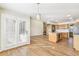 View of living room and kitchen with hardwood floors, stone fireplace and stainless appliances at 6598 Pinewood Dr # 74, Parker, CO 80134