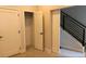 Hallway with a staircase, closet, and a sliding door to a room with office equipment at 3043 W 19Th Ave, Denver, CO 80204