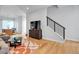 Bright living room with a staircase, wood floors, a TV set upon a wooden dresser at 3043 W 19Th Ave, Denver, CO 80204