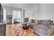 Comfortable living room featuring a plush gray sofa, modern rug, and bright natural light at 3043 W 19Th Ave, Denver, CO 80204