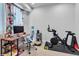 Cozy home office space with a comfortable desk, Peloton bike and floral curtains at 3043 W 19Th Ave, Denver, CO 80204