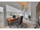 Loft area staged as a home office with a desk and natural lighting from a round window at 11101 E Alameda Ave # 202, Aurora, CO 80012