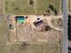 Bird's eye view showcasing the property, including the house, barn, and surrounding fields at 16491 County Road 32, Platteville, CO 80651