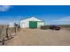 Exterior view of barn with green trim and a car parked nearby at 16491 County Road 32, Platteville, CO 80651