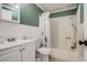 Cozy bathroom features a shower-tub combination, white wainscoting, and a floral shower curtain at 16491 County Road 32, Platteville, CO 80651