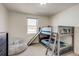 Bright bedroom showcasing a gray bunk bed with a slide, a beanbag chair, and a large window at 16491 County Road 32, Platteville, CO 80651