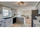 Open kitchen offers stylish gray cabinets, marble counter tops and newer appliances at 16491 County Road 32, Platteville, CO 80651