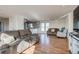 Bright, open-concept living room with wood floors flows into the adjoining kitchen at 16491 County Road 32, Platteville, CO 80651