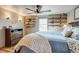 Comfortable main bedroom with a ceiling fan, built-in shelves, a wood dresser, and light-colored walls at 16491 County Road 32, Platteville, CO 80651