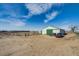 Large outbuilding with green doors on a spacious property ready for all your hobbies at 16491 County Road 32, Platteville, CO 80651