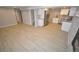 Spacious basement with tile floor, a kitchen, and stone fireplace at 5585 W 51St Pl, Denver, CO 80212