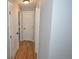 Hallway with wooden floors and white doors leading to various rooms in the house at 5585 W 51St Pl, Denver, CO 80212