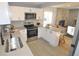 Beautiful kitchen featuring stainless steel appliances, white cabinets, and a breakfast bar at 5585 W 51St Pl, Denver, CO 80212