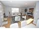 Bright living room featuring a stone fireplace, hardwood floors, and contemporary furnishings at 5585 W 51St Pl, Denver, CO 80212