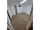Compact basement featuring neutral carpet and white walls, perfect for flexible living or storage at 12063 E Arizona Dr, Aurora, CO 80012