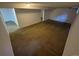 Spacious basement featuring neutral carpet and white walls, perfect for flexible living or storage at 12063 E Arizona Dr, Aurora, CO 80012