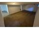 Spacious basement featuring neutral carpet and white walls, perfect for flexible living or storage at 12063 E Arizona Dr, Aurora, CO 80012