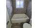 Bathroom with a tub shower and tiled backsplash at 12063 E Arizona Dr, Aurora, CO 80012