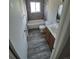 Bathroom with tiled shower, modern vanity, and hardwood floors at 12063 E Arizona Dr, Aurora, CO 80012