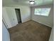 Bedroom featuring closet, window, and carpeted floors at 12063 E Arizona Dr, Aurora, CO 80012