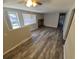 Welcoming living room with wood-look flooring, a brick fireplace, and bright natural light from large windows at 12063 E Arizona Dr, Aurora, CO 80012