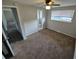 Spacious main bedroom leading to bath featuring a ceiling fan and neutral walls at 12063 E Arizona Dr, Aurora, CO 80012