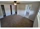 Main bedroom leading to bath with ceiling fan and plush carpeting at 12063 E Arizona Dr, Aurora, CO 80012
