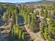 Aerial view of the condo next to the river running through the forest at 805 Columbine Rd # 202, Breckenridge, CO 80424