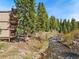 Exterior shot of condo next to the river running through the forest at 805 Columbine Rd # 202, Breckenridge, CO 80424