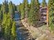 Riverside condo with balconies and ample natural light, surrounded by lush greenery at 805 Columbine Rd # 202, Breckenridge, CO 80424