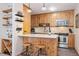 Charming kitchen featuring knotty wood cabinetry, breakfast bar, and stainless steel appliances at 805 Columbine Rd # 202, Breckenridge, CO 80424