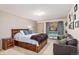 Comfortable bedroom with a wood bed frame, carpeted floors, large window, and a couch at 805 Columbine Rd # 202, Breckenridge, CO 80424