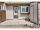 A cozy back patio features a door, window, and storage area, perfect for outdoor relaxation at 9618 W Chatfield Ave # B, Littleton, CO 80128