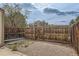 A fenced backyard area featuring a gravel ground cover and a view of neighboring houses, providing privacy at 9618 W Chatfield Ave # B, Littleton, CO 80128