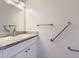 Bright bathroom featuring a granite countertop and convenient accessibility grab bars at 9618 W Chatfield Ave # B, Littleton, CO 80128