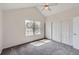 Bright bedroom showcasing carpet flooring, vaulted ceilings, and a closet for ample storage at 9618 W Chatfield Ave # B, Littleton, CO 80128