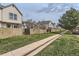 Charming townhome community featuring well-maintained wooden fences and lush green spaces on a partly cloudy day at 9618 W Chatfield Ave # B, Littleton, CO 80128