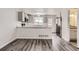 Bright kitchen featuring modern stainless steel appliances, light cabinets, and stylish floors at 9618 W Chatfield Ave # B, Littleton, CO 80128
