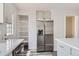 Kitchen with stainless steel appliances, featuring laminate countertops, and open shelving at 9618 W Chatfield Ave # B, Littleton, CO 80128