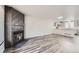 Open-concept living space featuring a fireplace, gray flooring, and seamless flow to the kitchen at 9618 W Chatfield Ave # B, Littleton, CO 80128
