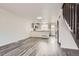 Spacious living room with an open layout, gray floors, and a partial view of the staircase at 9618 W Chatfield Ave # B, Littleton, CO 80128