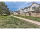 A street view capturing the house exterior, framed by a green lawn and sidewalk for neighborhood charm at 9618 W Chatfield Ave # B, Littleton, CO 80128