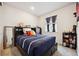 This cozy bedroom features a dark wood bedframe, storage, and plush blue bedding at 226 S Shady Grove Ct, Aurora, CO 80018